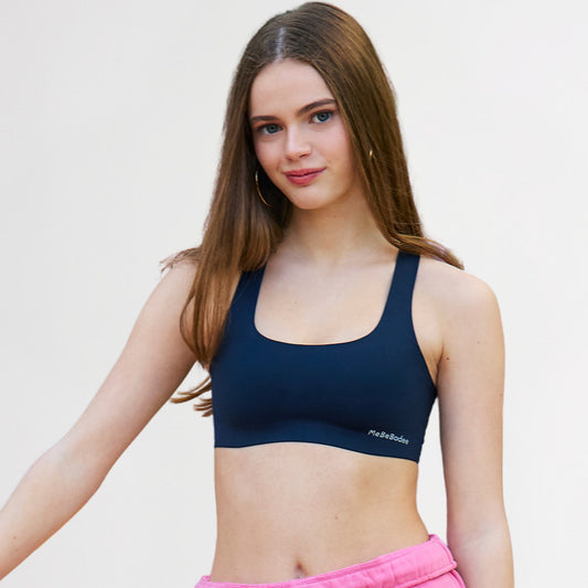 Teen Girl wearing a navy sports bra with a visible 'MeBeBodee' brand logo on a light background